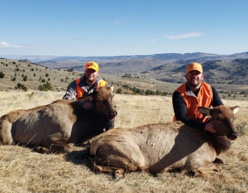 Two cow elk hunters posing after the hunt